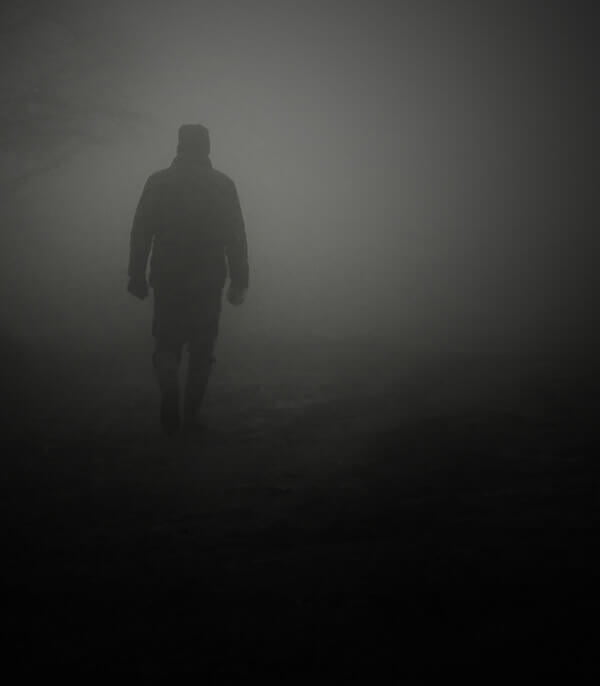man standing in fog