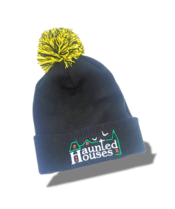 a black and yellow beanie with a yellow pom haunted houses brand